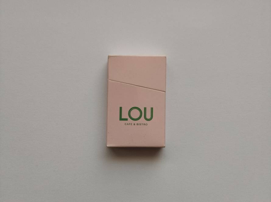 Lou Cafe & Bistro minimalist green logo on pastel pink box