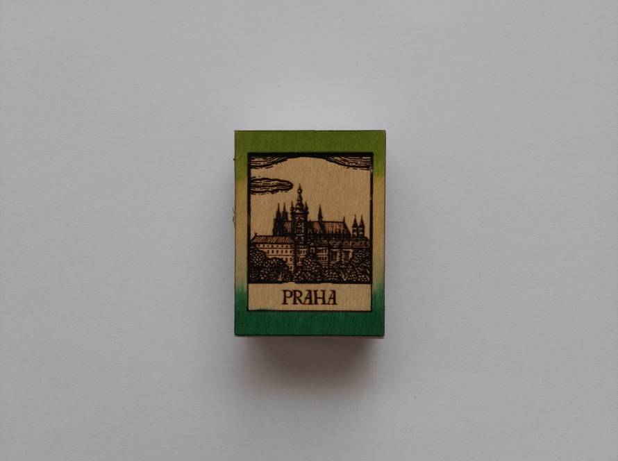 Woodcut-style matchbox featuring Prague (Praha). Unique engraved wood with fine detail.