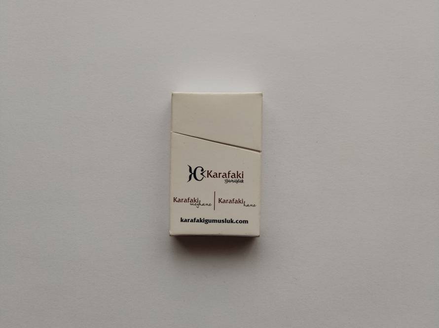 Promotional matchbox for “Karafaki Gümüşlük” and “fed elektromekanik.” Minimalist cream design with website print.