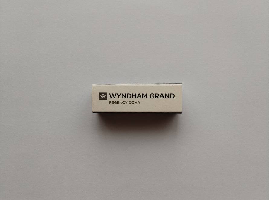 Side panel of Wyndham Grand Regency Doha matchbox with English branding