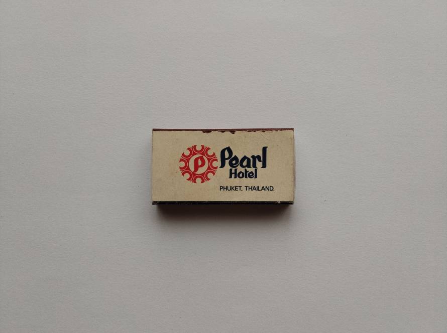 Pearl Hotel Phuket logo with red circular emblem on cream background