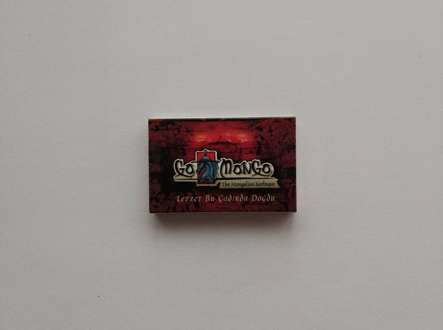 “Go Mongo – The Mongolian Barbeque” restaurant promotional matchbox; red & black dramatic background with Mongolian warrior logo. Reverse likely includes brand details.