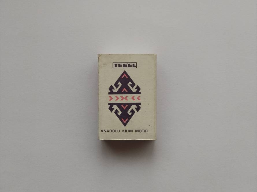 “TEKEL – Anadolu Kilim Motifi” matchbox; traditional Anatolian rug motif design. Reverse shows 1989 print date & price (75 TL). Collectible state-issued design.