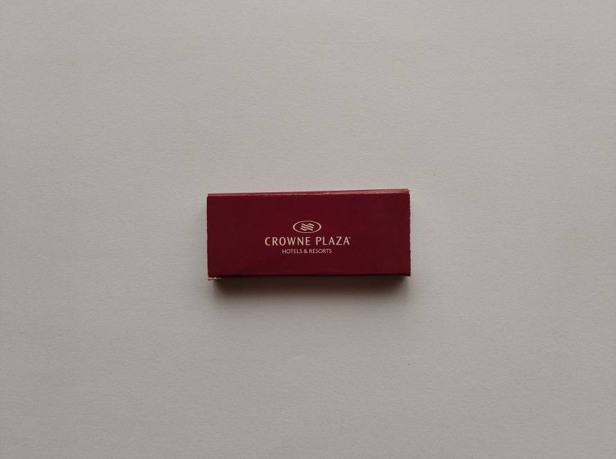 Crowne Plaza Hotels & Resorts logo on burgundy background