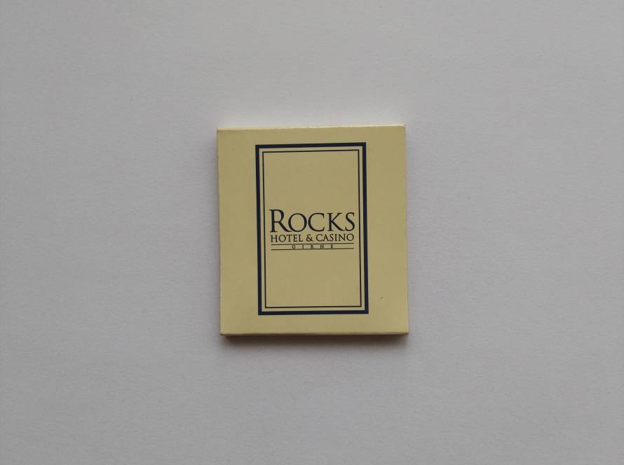 “Rocks Hotel & Casino – Girne” promotional matchbox; minimalist beige design with navy frame typography