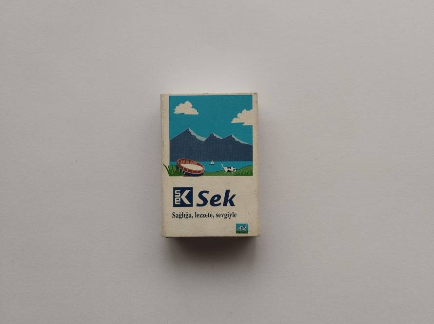 “SEK – Sağlığa, lezzete, sevgiyle” promotional matchbox; countryside dairy illustration branding.