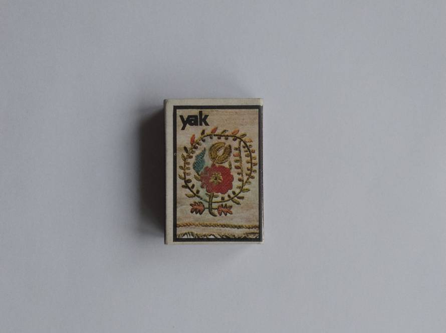 “Yak” branded matchbox featuring traditional Anatolian-style floral motif illustration. Decorative collectible piece.