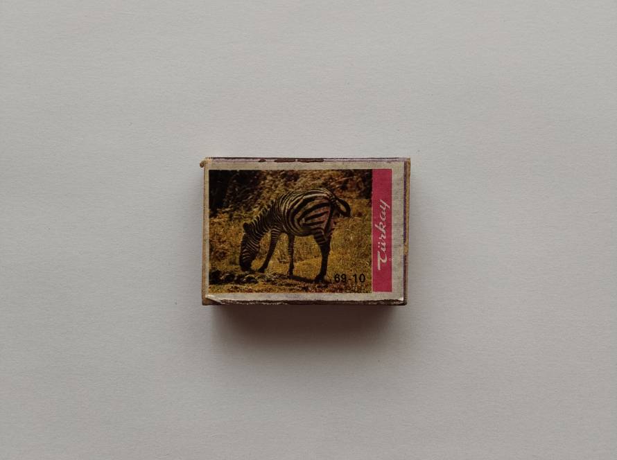 “Türkay” animal series no. 69-10 featuring zebra grazing scene. Vertical pink Türkay branding strip on right side.