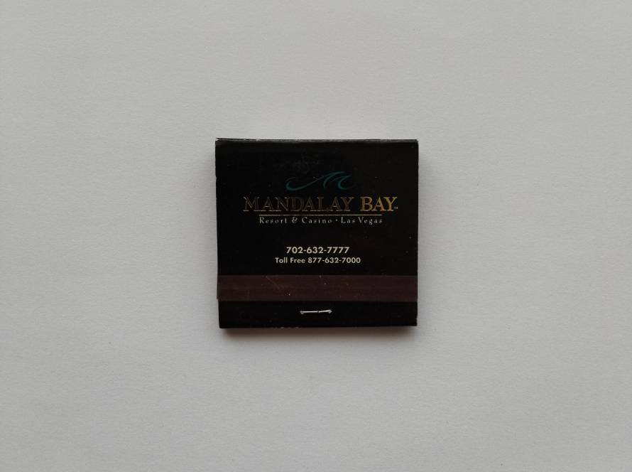 “Mandalay Bay – Resort & Casino, Las Vegas” matchbook with contact numbers. Reverse features illuminated hotel façade at sunset.