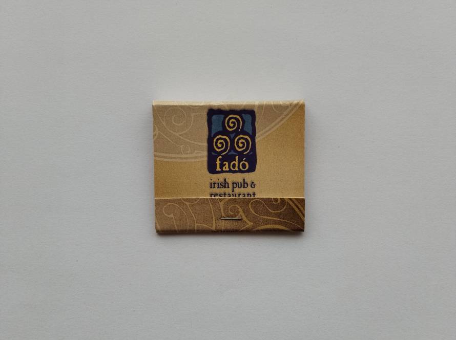 “Fadó Irish Pub & Restaurant” matchbook with Celtic-inspired spiral motifs and Gaelic phrase “Ól, ceol, agus craic!” (Drink, music and fun).