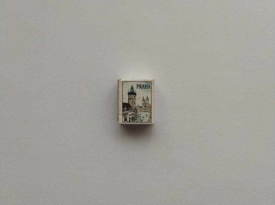 Small souvenir matchbox with an illustration of Praha (Prague) city architecture and tower skyline. Typical tourist souvenir design.
