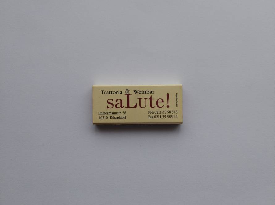 Matchbox for Trattoria & Weinbar “saLute!”, Düsseldorf. Clean typographic design with address and contact details.