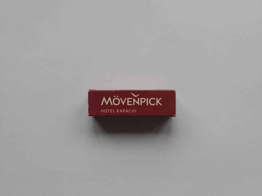 Matchbox from Mövenpick Hotel Karachi. Clean red branding with well-known international hotel chain identity.