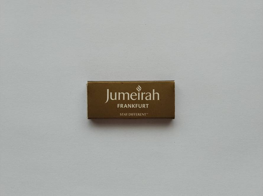 Jumeirah Frankfurt branded matchbox with elegant gold finish and minimalist luxury typography; premium hotel promotional item.