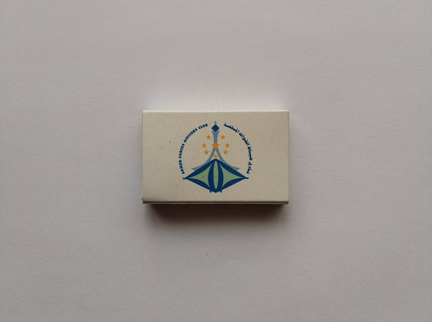 Armed Forces Officers Club matchbox with bilingual Arabic-English emblem and star motif, representing official institutional promotional material from Abu Dhabi.