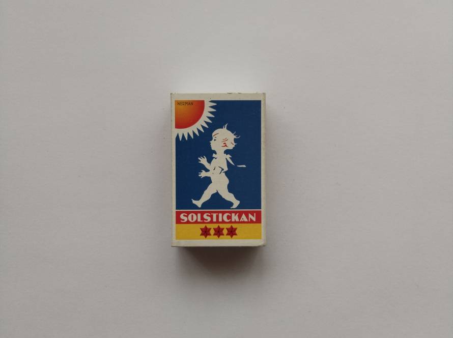 “Solstickan” Swedish Match box featuring iconic child logo and charity text on reverse. Proceeds support Solstickan Foundation. Classic Scandinavian design collectible with barcode edition.