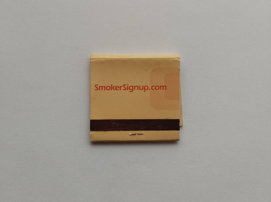 Promotional matchbook advertising SmokerSignup.com. Typical early-2000s marketing item linked to tobacco promotions.