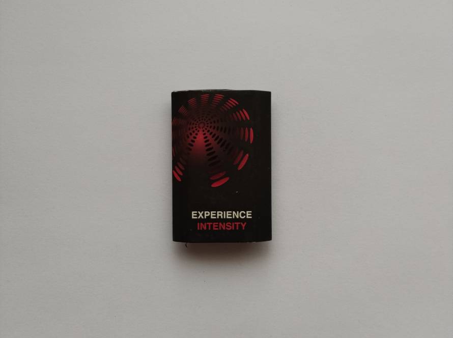 Contemporary black matchbox with red spiral graphic and slogan “Experience Intensity.” Modern design likely used for promotional or lifestyle branding.