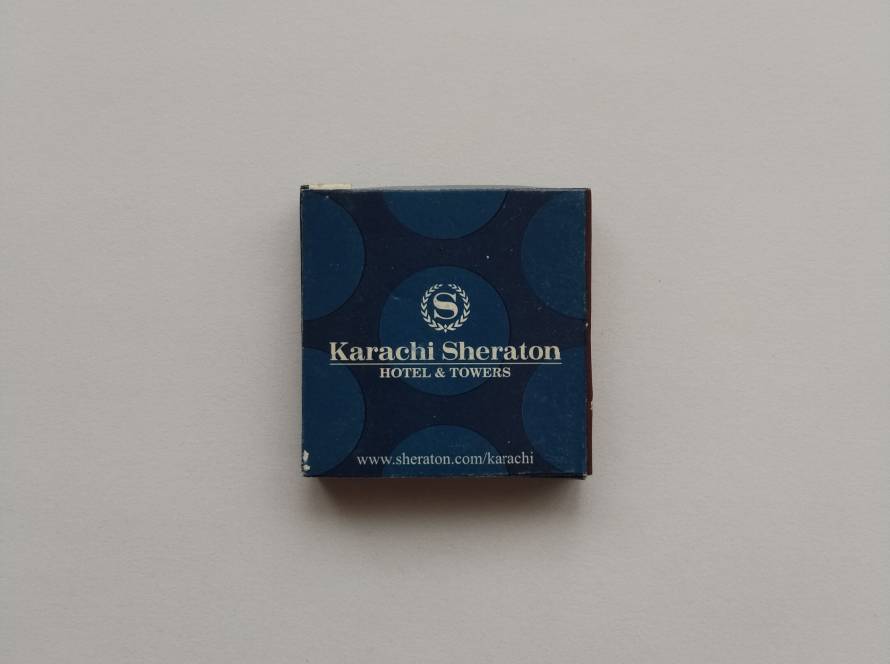 Vintage matchbox from Karachi Sheraton Hotel & Towers, featuring the Sheraton emblem and hotel website.