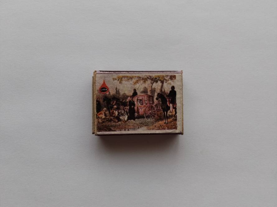 CIRA branded matchbox showing a traditional outdoor scene with a horse carriage and people resting, reflecting historical travel and daily life.