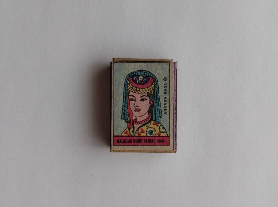 Matchbox featuring a female portrait labeled “Ankara Başlığı,” representing traditional headwear from the Ankara region.
