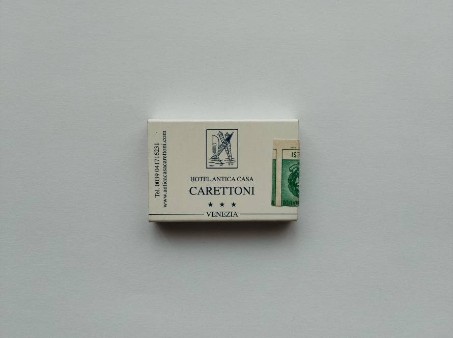 Hotel Antica Casa Carettoni promotional matchbox from Venice featuring classic Italian typography and emblem. Reverse side shows Hotel Lecchini branding with contact details, indicating period hotel marketing usage.