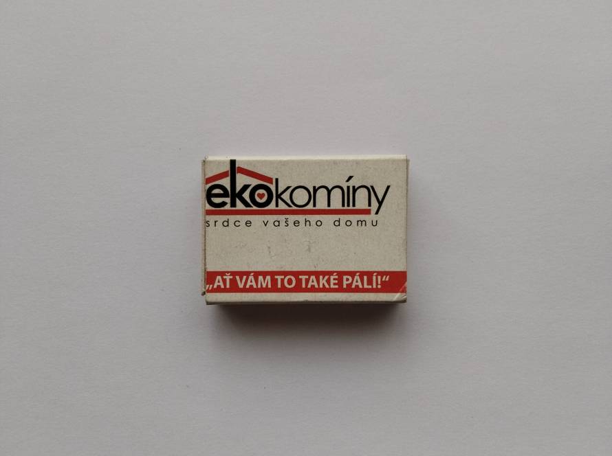 Czech “Ekokomíny” branded matchbox with slogan. Clean typography and clear branding for chimney services.
