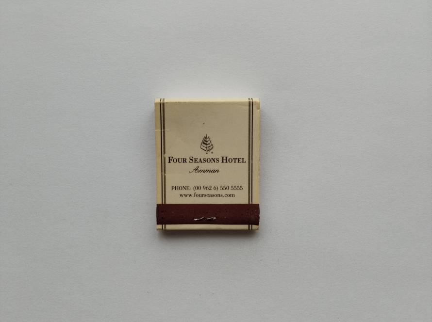 Matchbox from Four Seasons Hotel Amman, with classic luxury branding and contact details, appealing to hospitality collectors.