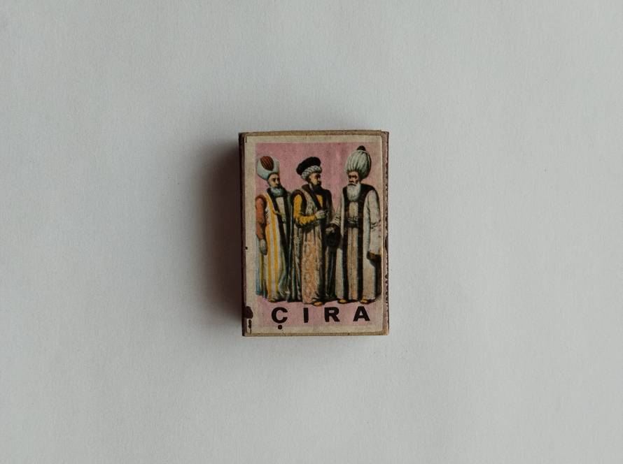 Classical-style statue depiction; evokes ancient art influences in vintage print form.