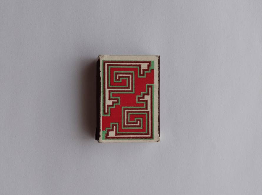 Abstract maze-like geometric red pattern; modernist design style.
