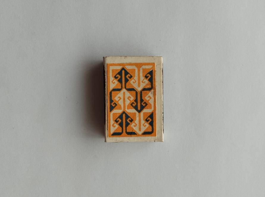 Traditional Anatolian motif design with stylized symmetrical elements in orange and dark tones.