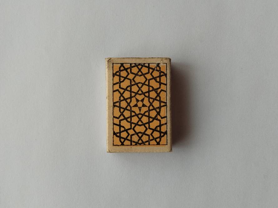 Kav Orman Sanayii safety matchbox featuring intricate black geometric star lattice motif on orange background; reverse marked “Made in Turkey” and “Ave. 40 St.”