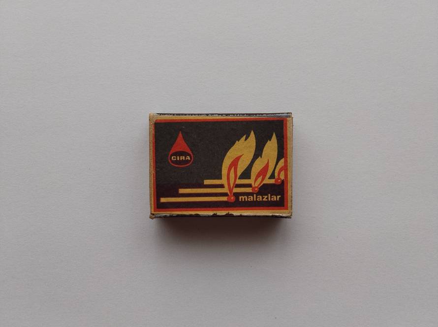 Retro CIRA Malazlar branded matchbox featuring stylized burning match graphics on dark background with red-yellow color palette.