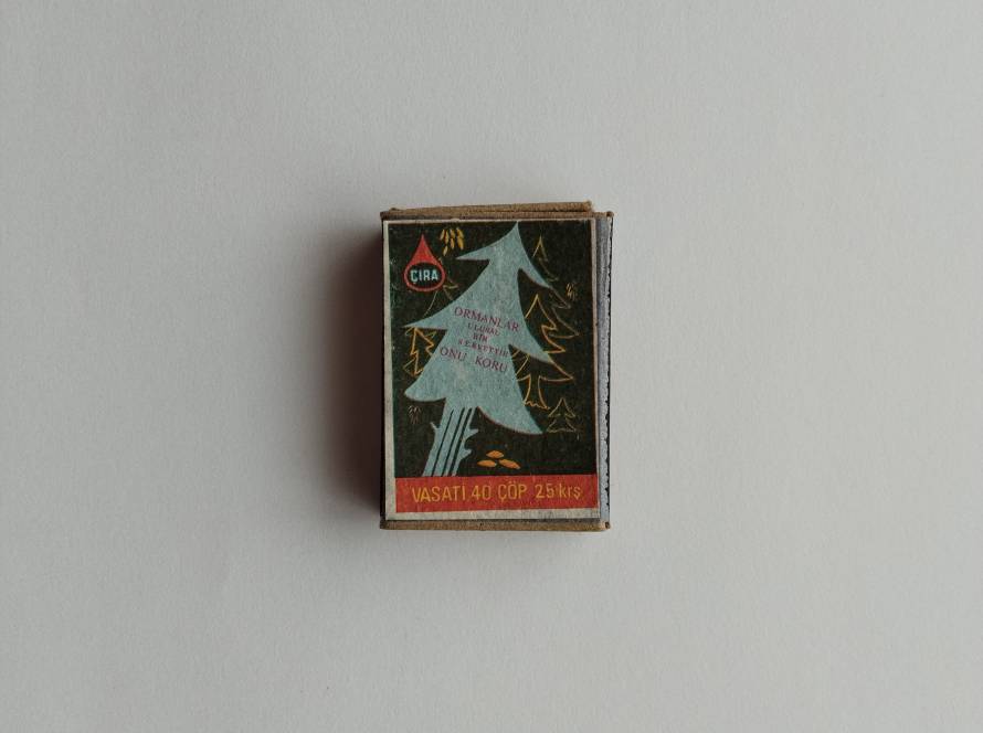 Vintage ÇIRA matchbox with stylized pine tree artwork and slogan “Ormanlar Ulusal Bir Servettir Onu Koru” promoting forest conservation.