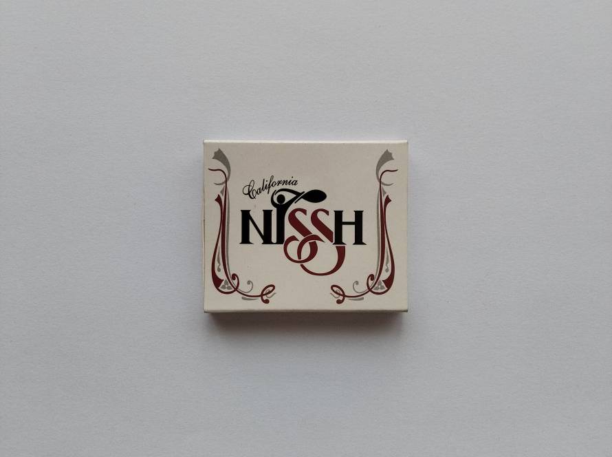 Promotional matchbox for Nissh California, a hospitality and dining venue in Ankara. Features business branding and contact details on the reverse side.