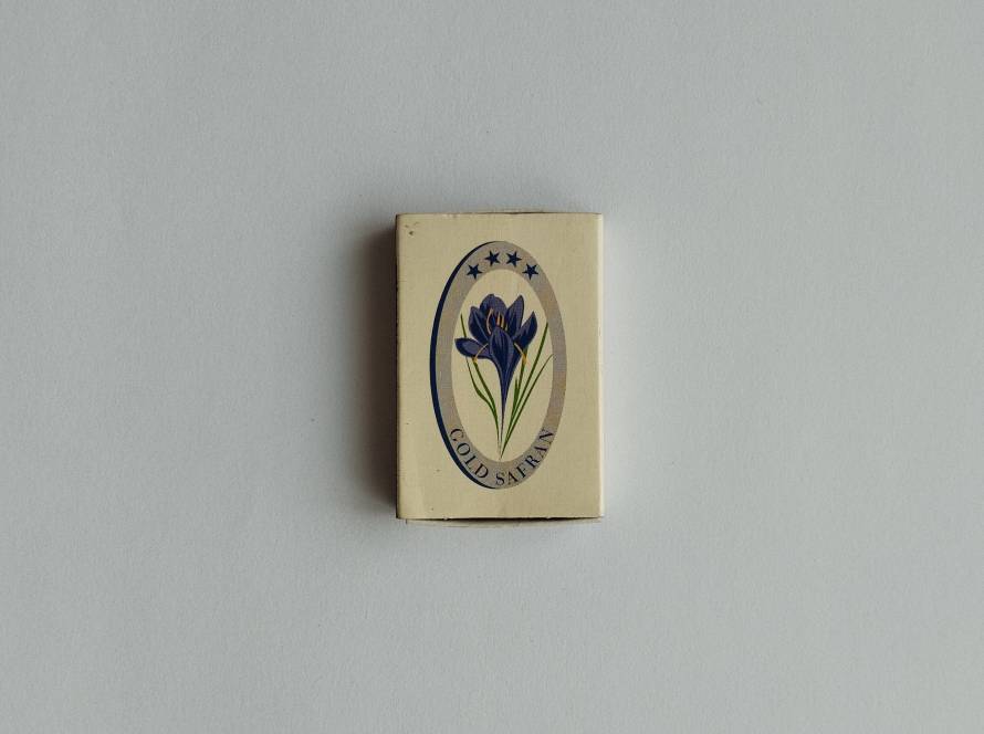 Reverse side of Gold Safran Hotel promotional matchbox with contact information and address.