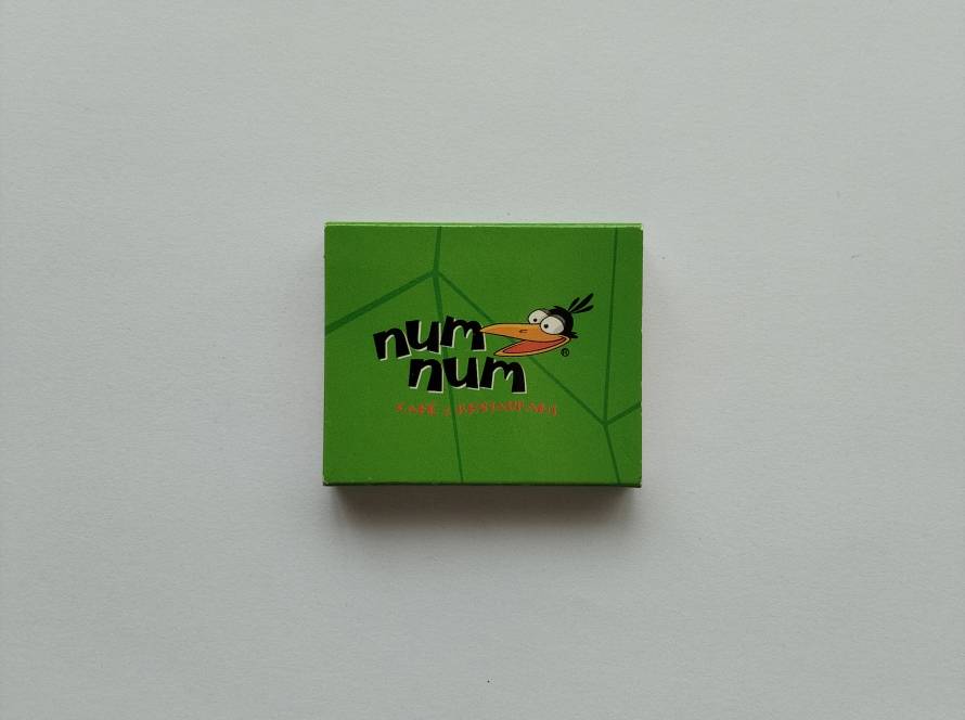 Num Num Café & Restaurant promotional matchbox. Reverse side highlights multiple restaurant locations and mascot branding.