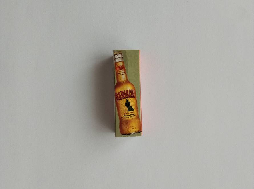 Mariachi beer themed promotional matchbox featuring a beer bottle illustration.