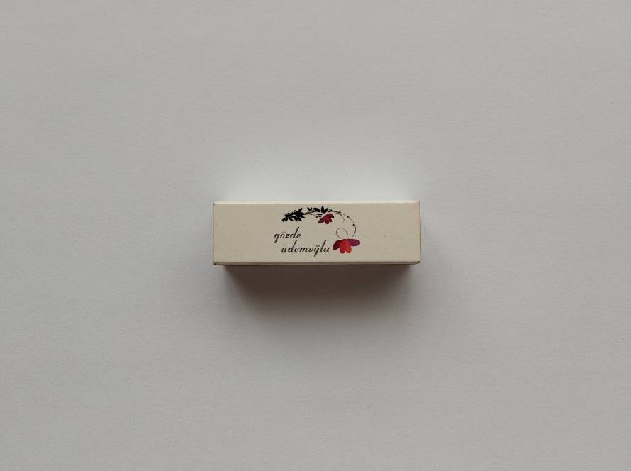 Gözde Ademoğlu promotional matchbox featuring floral-themed branding, likely related to fashion or boutique retail.