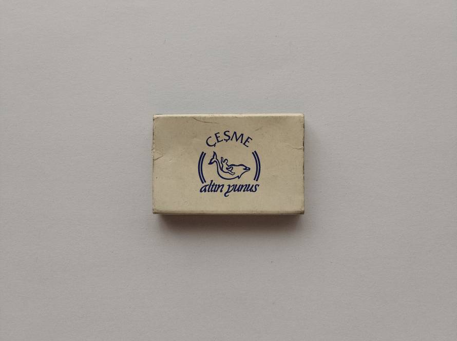 Çeşme Altın Yunus hotel promotional matchbox featuring the iconic dolphin logo. A recognizable hospitality collectible from the Turkish tourism industry.