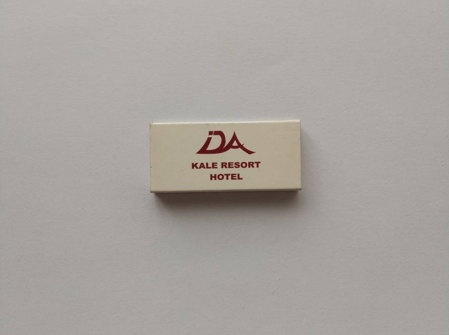 Promotional matchbox for DA Kale Resort Hotel, featuring simple red logo and hospitality branding.