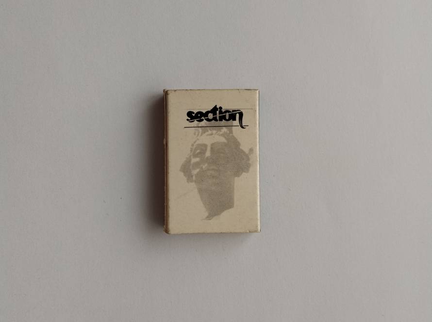 Promotional matchbox for Section fashion retail brand, featuring classical statue artwork and minimalist design.