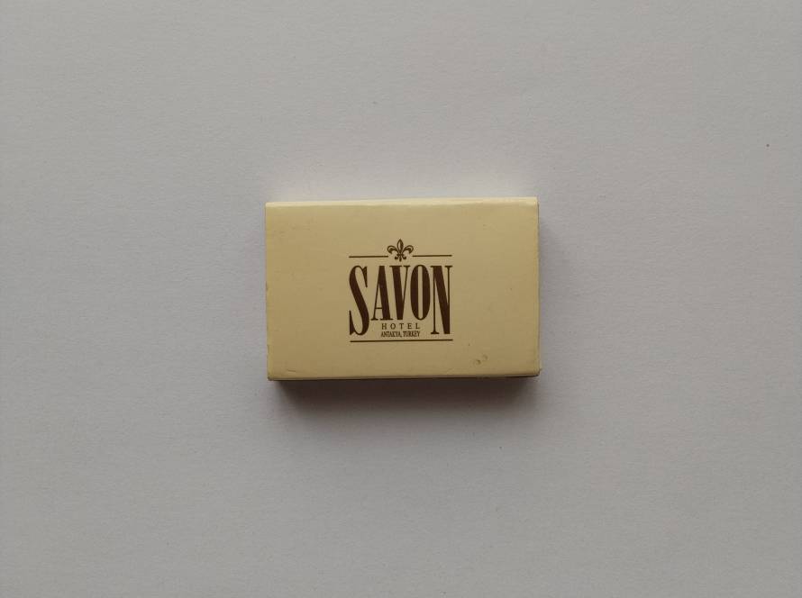 Promotional matchbox for Savon Hotel in Antakya, featuring elegant vintage-style typography and hospitality branding.