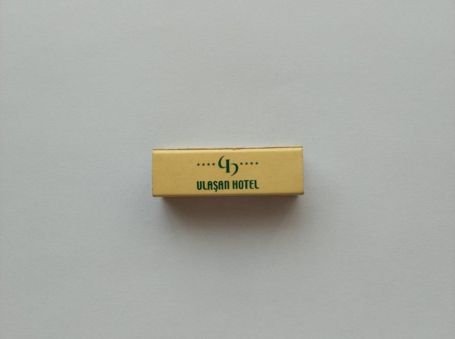 Promotional matchbox for Ulaşan Hotel in Ankara, featuring hotel branding on the front and complete contact information on the reverse.