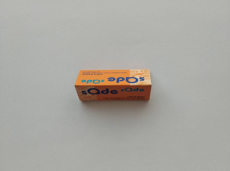Advertising matchbox for Sade Cafe & Bistro in Ankara, displaying colorful branding and venue contact information.