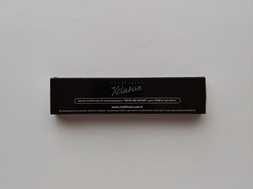 Promotional matchbox for ClubFinans Xclusive membership program, featuring campaign and website information.