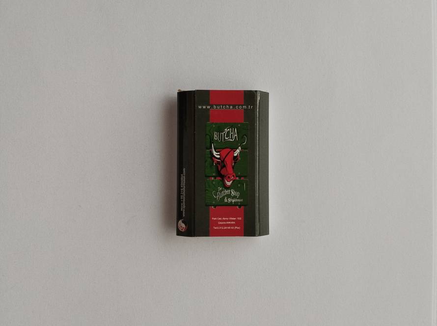Advertising matchbox for Butcha The Butcher Shop & Steakhouse in Ankara, featuring the restaurant’s iconic bull-head logo and contact details.