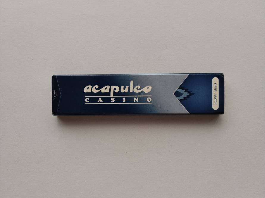 Promotional matchbox for Acapulco Casino, associated with Pasha Group, featuring a blue gradient design, casino branding, and contact details for both the Istanbul office and Acapulco Casino in Northern Cyprus.
