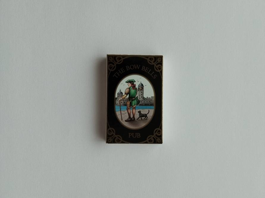 Promotional matchbox for The Bow Bells Pub in Kalamış, Istanbul. Features decorative pub-themed artwork on the front and venue contact details on the reverse, reflecting British pub-style branding.