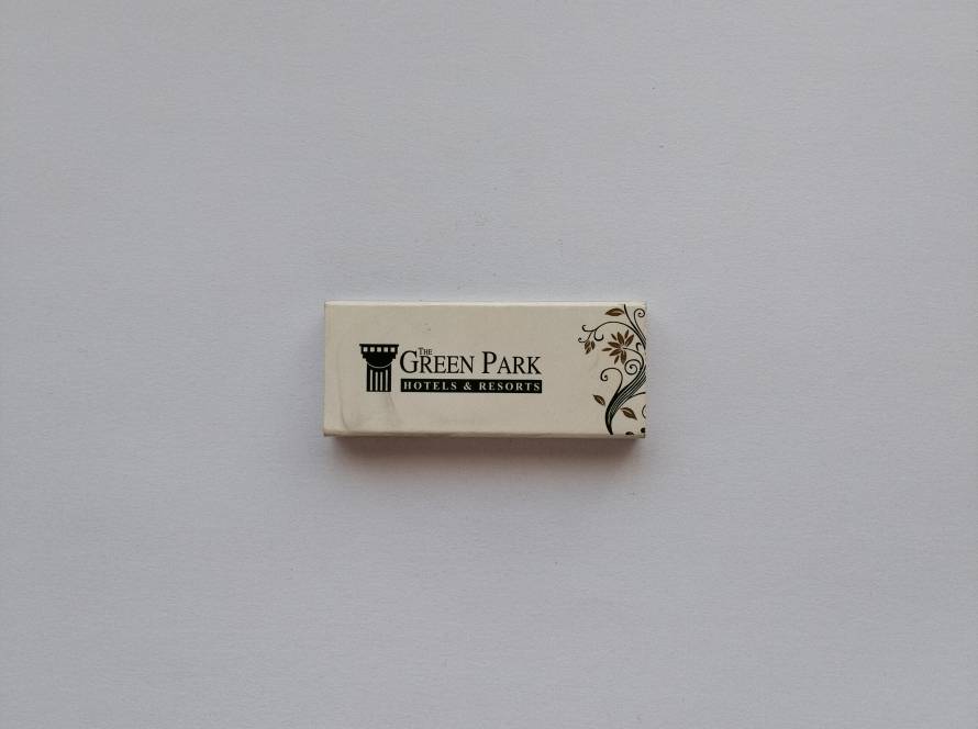 The Green Park Hotels & Resorts branded matchbox with hotel chain logo and website information.